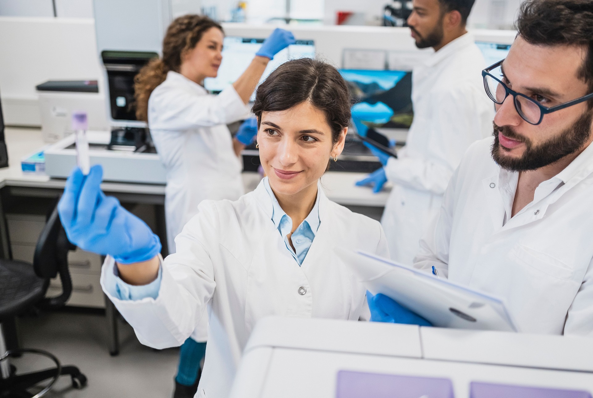 Diverse Lab Technicians Engaged in Scientific Research